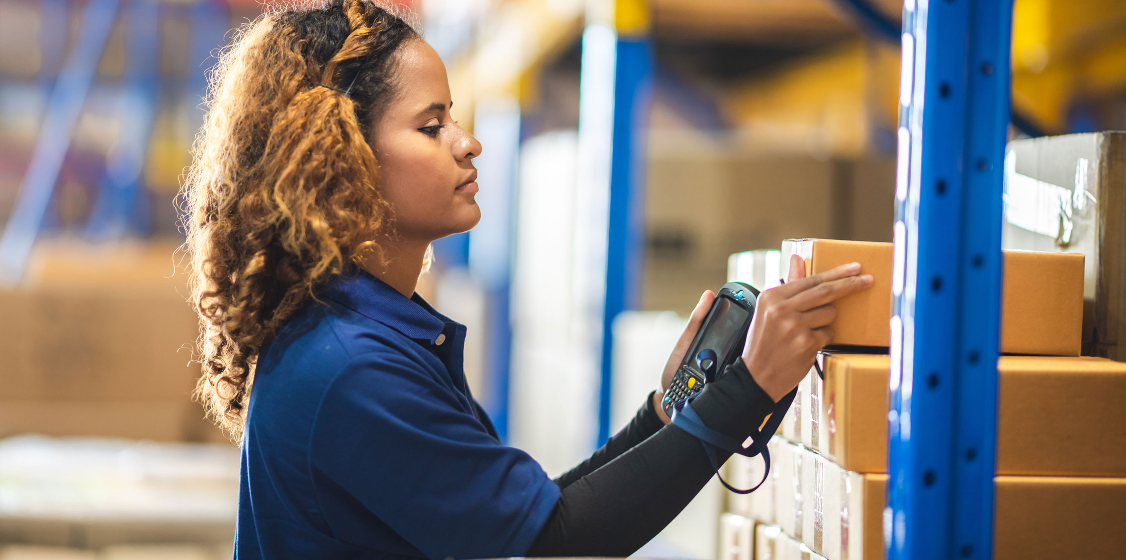 female distribution employee scanning pricing code to determine different pricing strategies