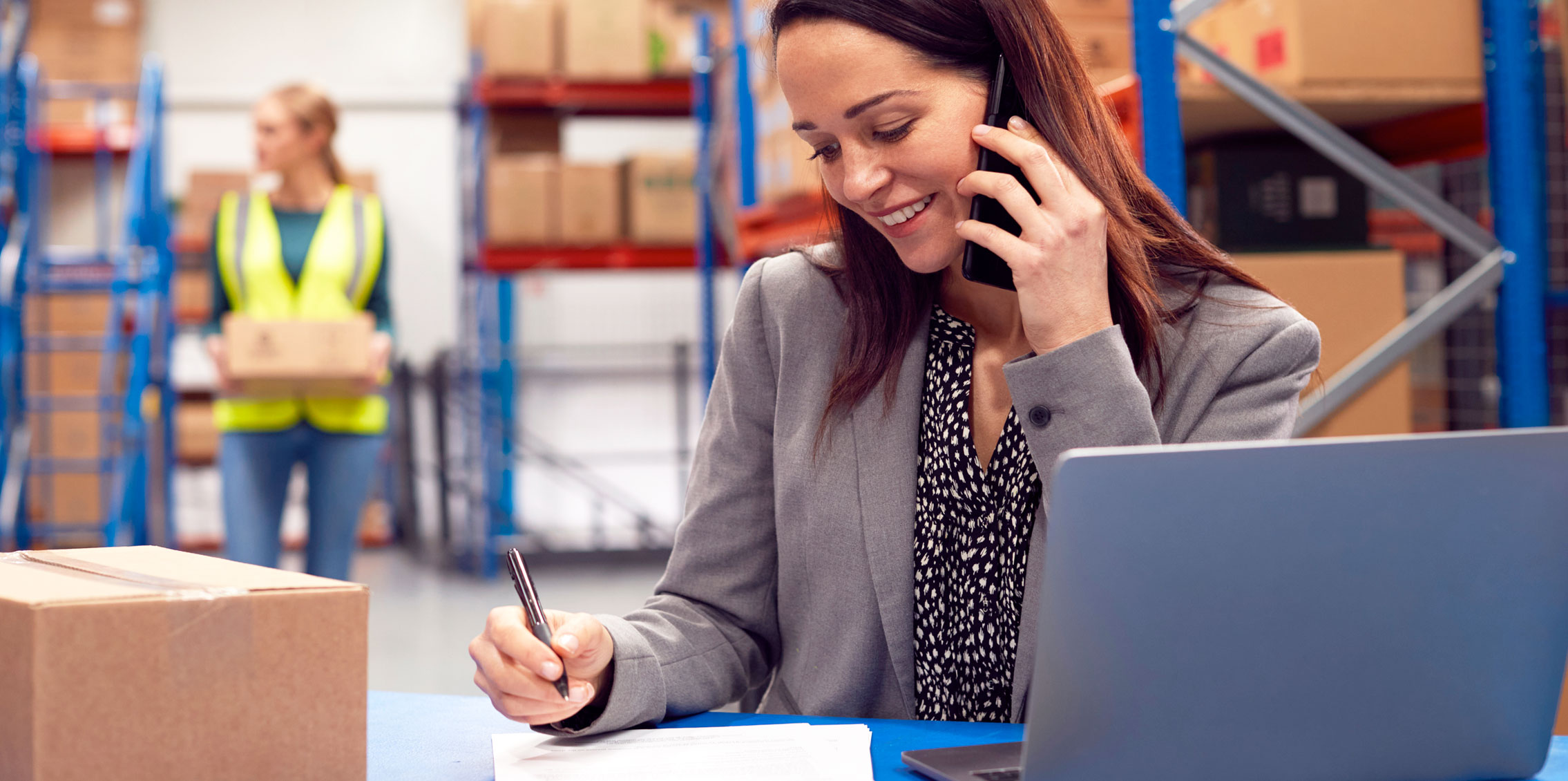 woman working in warehouse on CRM for wholesale distributors