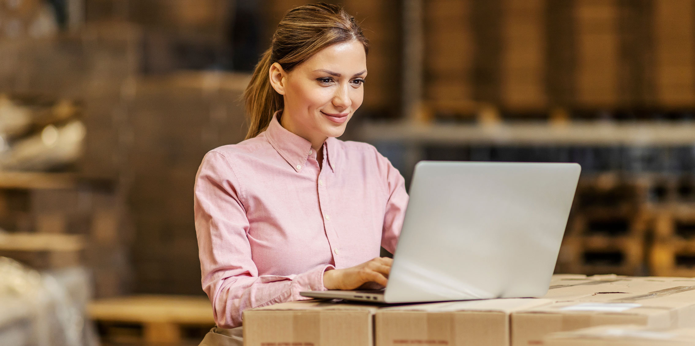 woman in warehouse using crm to improve time management skills, increase sales, refine sales scripts and sales activities