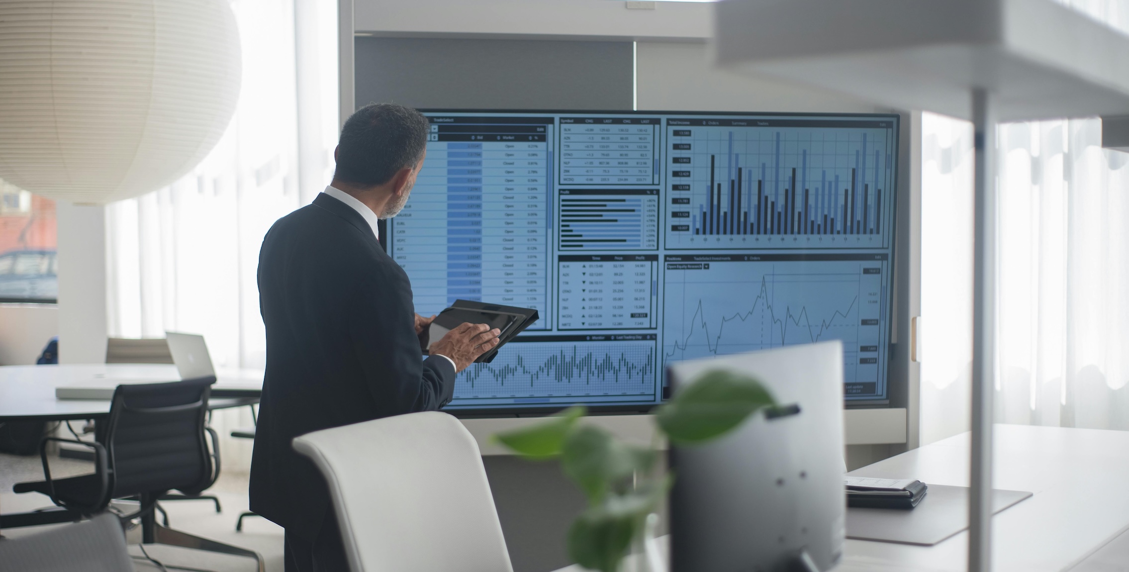 Person reviewing CRM data on large screen
